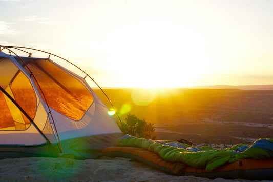 Camping tent on a cliff at golden hour